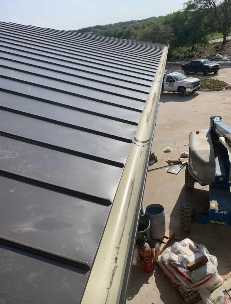Standing seam panel and gutter detail on a metal roofing jobsite in Middleton